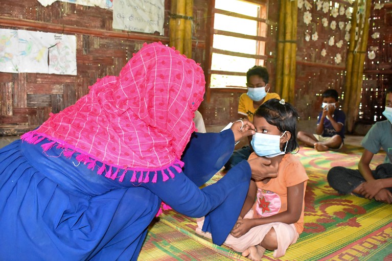 Halima (left) leading a Covid-19 related health and hygiene session with children in her Rohingya refugee camp in Cox’s Bazaar region of Bangladesh in August 2020. Photo credit: Inmanuel Chayan Biswas/Caritas Bangladesh.