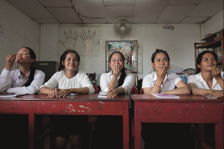 Students of the Caritas Australia-supported Deaf Development Program learning Cambodian sign language. They are also taught how to write in Khmer and take maths and social science classes as part of the two year course. Photo credit: Richard Wainwright/Caritas Australia.