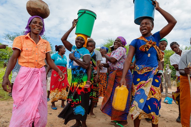 Community members from Msuna Hills dance and sing about water next to the new water pipe in Msuna hills, Zimbabwe, 2018. Photo credit: Richard Wainwright/Caritas Australia.